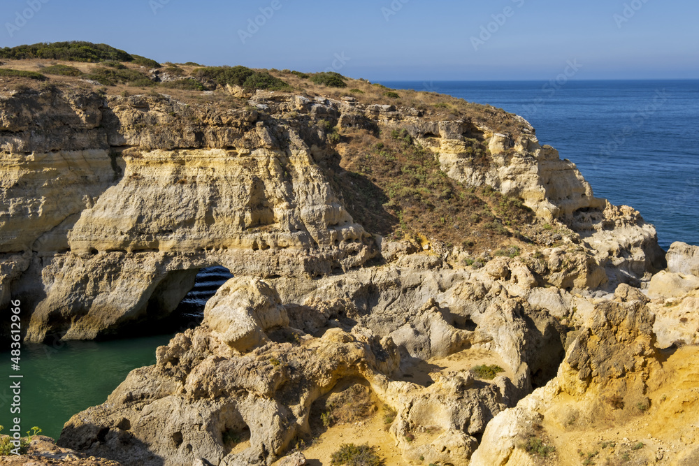 yellow cliff, sand and clear water at the Carvalho cape, Algarve, Portugal