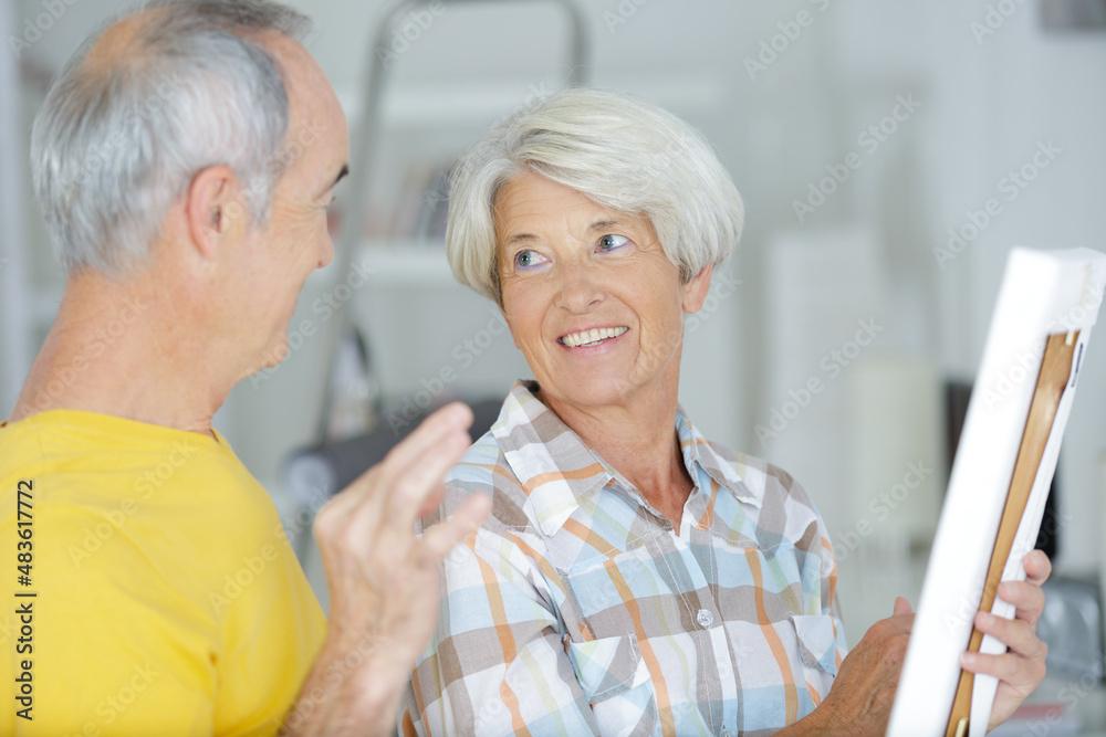 nice man standing next to his wife while hugging her