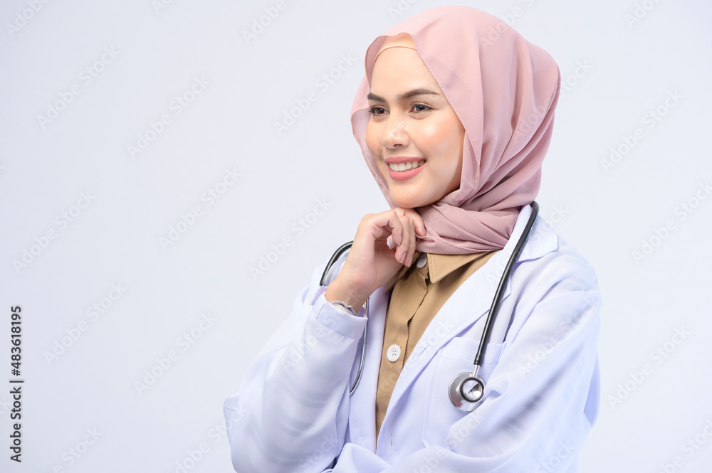Female muslim doctor with hijab over white background studio. Female muslim doctor with hijab over white background studio.