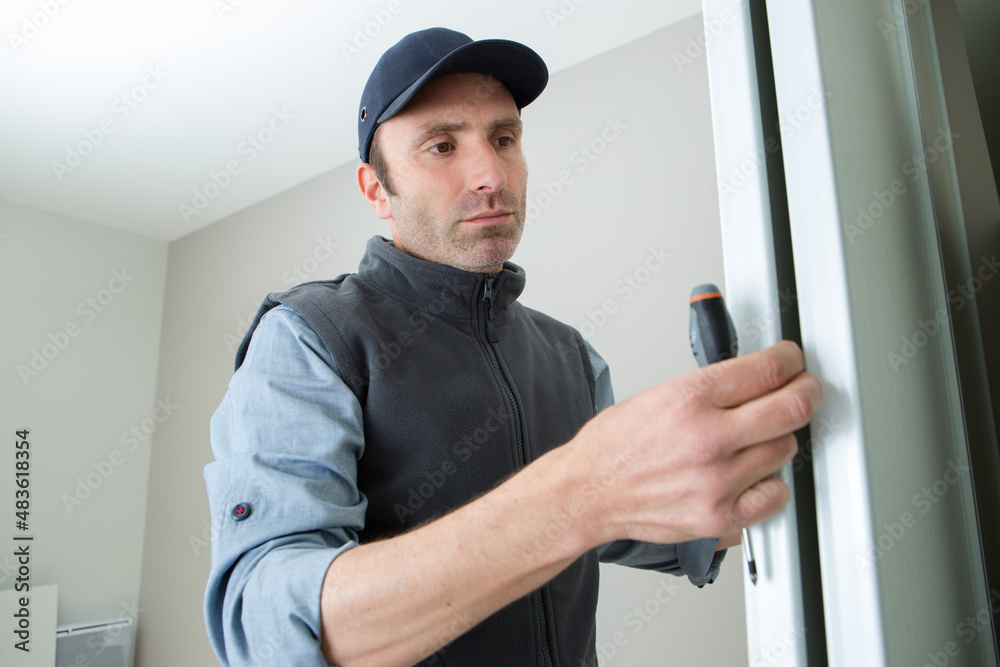 handyman install the new door lock in the room