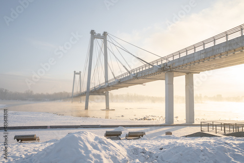 snow-covered bridge over the river in the winter in the sunrise Russia, Krasnoyarsk Vinogradovsky Bridge or Vantovy Bridge photo