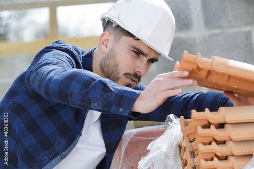 builder preparing for roof tiles replacement photo