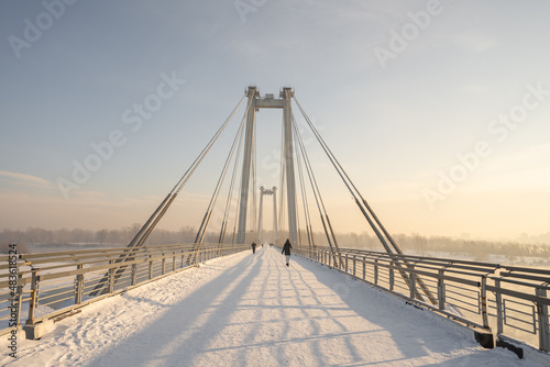 snow-covered bridge over the river in the winter in the sunrise Russia, Krasnoyarsk Vinogradovsky Bridge or Vantovy Bridge photo