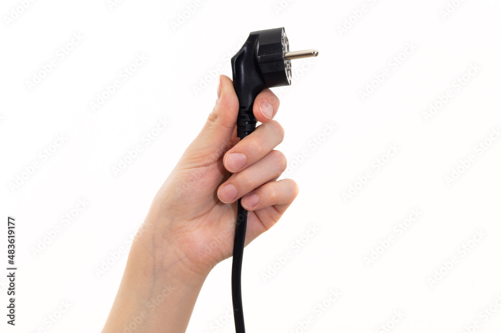 The concept girl holds a power cable plug in her hand The concept girl holds a power cable plug in her hand