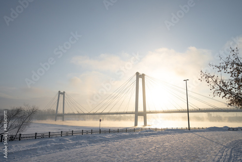 snow-covered bridge over the river in the winter in the sunrise Russia, Krasnoyarsk Vinogradovsky Bridge or Vantovy Bridge photo