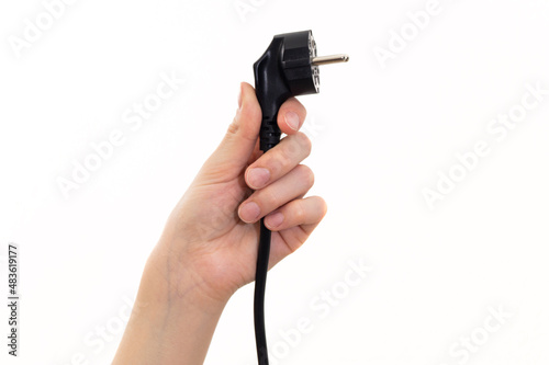 The concept girl holds a power cable plug in her hand
