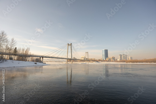 snow-covered bridge over the river in the winter in the sunrise Russia, Krasnoyarsk Vinogradovsky Bridge or Vantovy Bridge photo