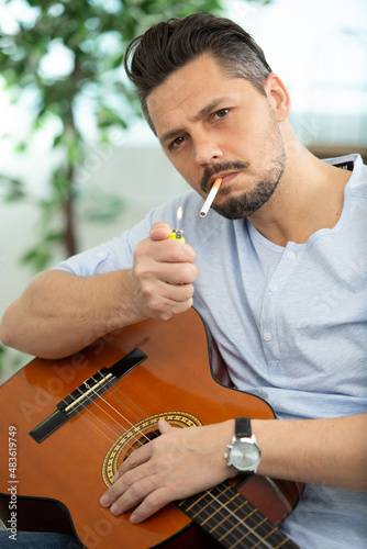 musician is lighting a cigarette