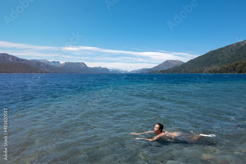 Person swimming on the lake in the mountains  