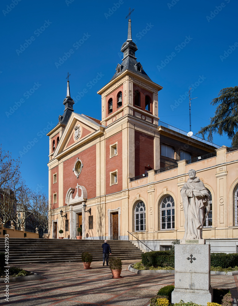 Principal facade of the The Royal Basilica of our Lady of Atocha, with the statue  of Santo Domingo de Guzman, founder of the Dominicans, in the foreground. Madrid, Spain.