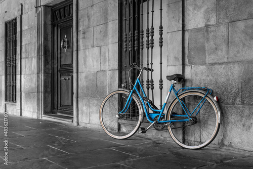 blue classic bike parked on old town street.