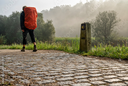 Fényképezés pilgrim walking on the way to St James (Santiago) on a foggy day in Galicia