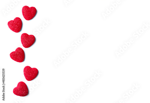 Border from red marmalade hearts isolated on white background. Valentine's Day concept.