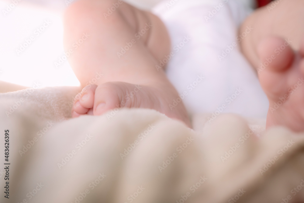 Newborn foot in bed with soft fabrics. Newborn foot in bed with soft fabrics.