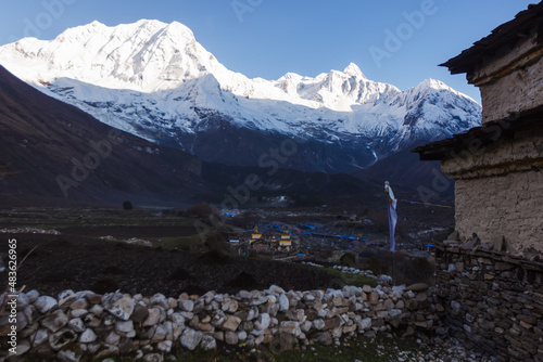 A large settlement in the Manaslu region against the backdrop of the Himalayas