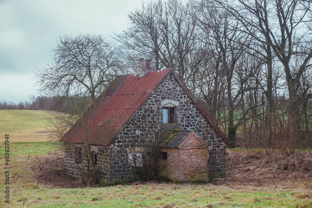Old abandoned stone house in winter Denmark