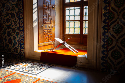 Islamic background photo. Rahle or lectern in the window of a mosque.
