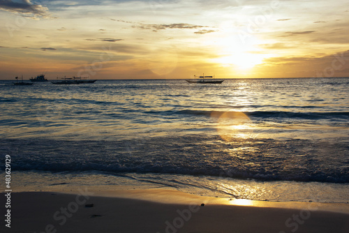 Sunset on the coast. Sea and sand. Sunset light. Beautiful nature. Seascape. Tropical climate. Philippines. Boracay Island. Exotic nature.