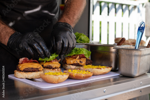 Chef preparing cheese burgers on a table