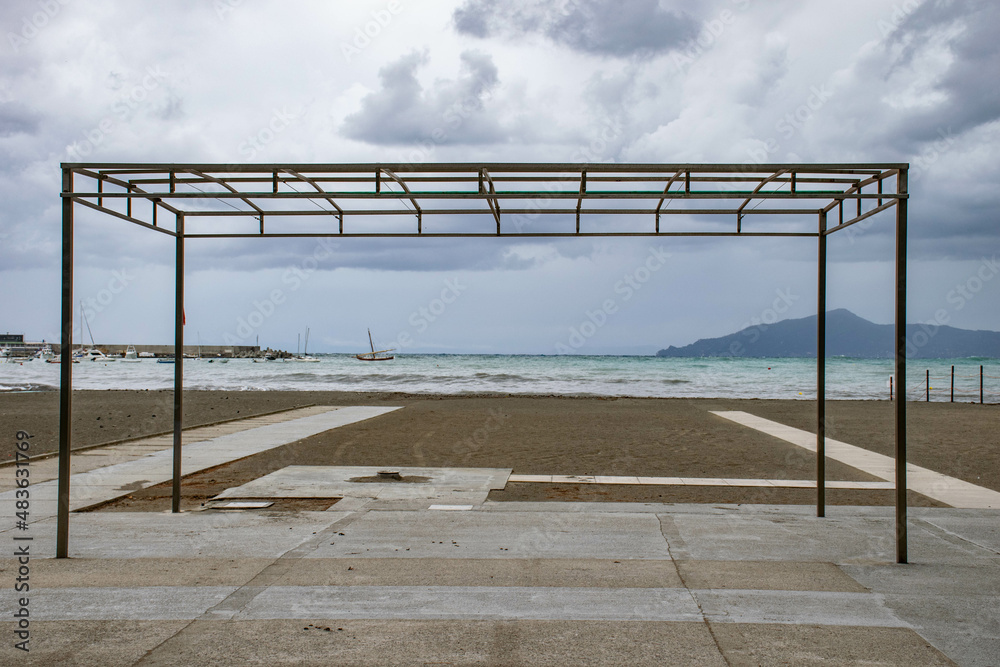 Italy, Sestri Levante, September 2018 canopy on a deserted beach against the backdrop of the sea Italy, Sestri Levante, September 2018 canopy on a deserted beach against the backdrop of the sea