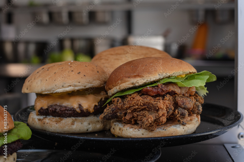 Burgers served on a black plate Burgers served on a black plate