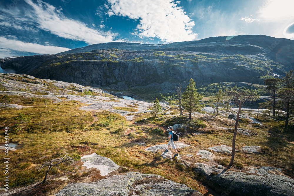 Kinsarvik, Hordaland, Norway. Young Woman Lady Tourist Traveler Backpacker Hiking In Hardangervidda Mountain Plateau. Famous Popular Destination.