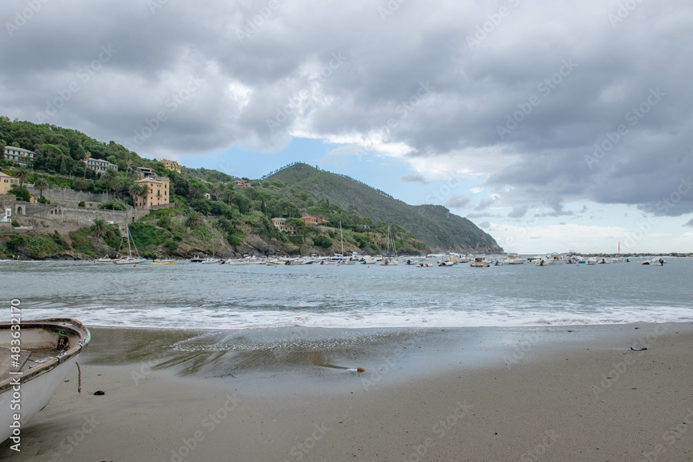 Cinque Terre, Sestri Levante, Italy, Liguria, September 2017. boat on a deserted beach, sea view, bay and cloudy sky