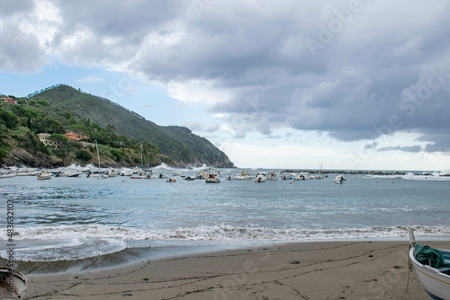 Cinque Terre, Sestri Levante, Italy, Liguria, September 2017. boat on a deserted beach, sea view, bay and cloudy sky