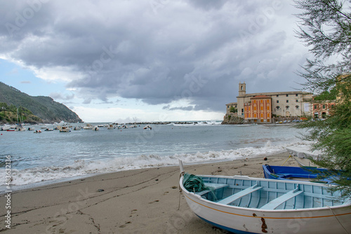 Cinque Terre, Sestri Levante, Italy, Liguria, September 2017. boat on a deserted beach, sea view, bay and cloudy sky