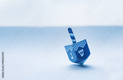 Hanukkah spinning top with Hebrew letters to which it revolves photo