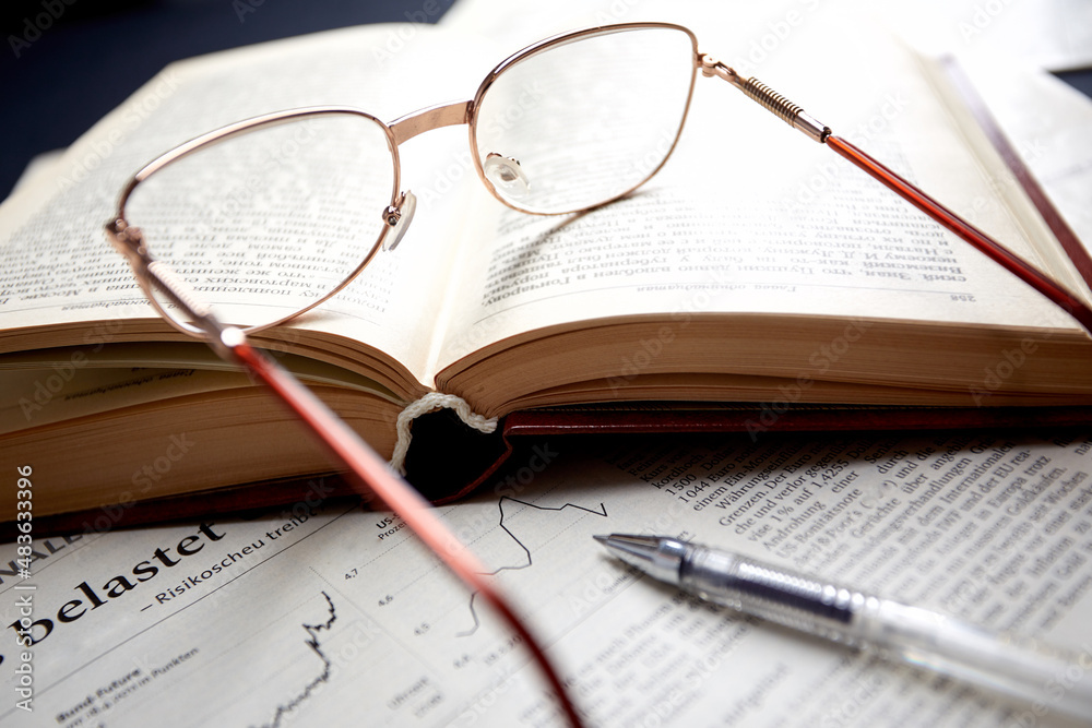 glasses on the book pages glasses on the book pages