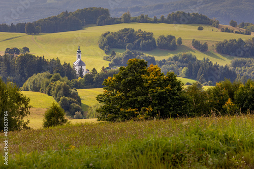 Summer landscape with forests and church.