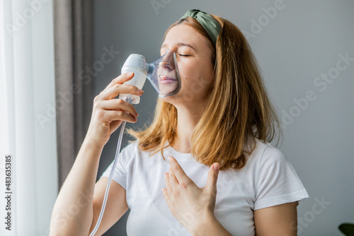 Photography middle-aged woman makes inhalation at home