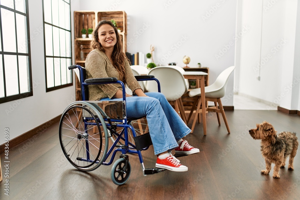 Φωτογραφία Young hispanic girl sitting on wheelchair at home with a happy and cool smile on face
