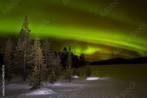 Northern lights over Inari lake in north finland, Ivalo. photo