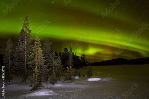 фотографія Northern lights over Inari lake in north finland, Ivalo.