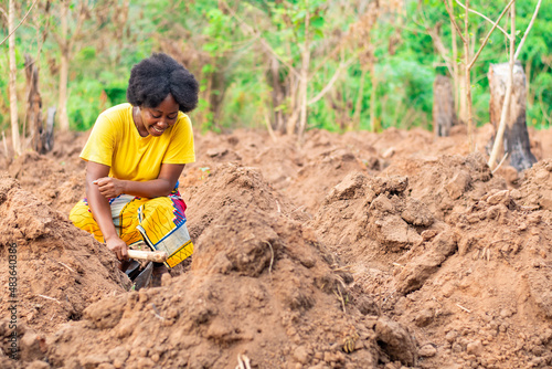 female african farmer making ridges on farm