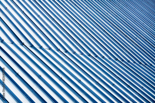 Corrugated metal profile roof installed on a barn house. The roof of corrugated sheet. Roofing of metal profile wavy shape. Modern roof made of metal. Metal roofing.