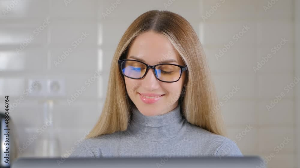 Happy white woman working on laptop at home during lockdown. Portrait of pretty Caucasian female using computer for distant work online. Freelancer person works on notebook pc in closeup 4k video Happy white woman working on laptop at home during lockdown. Portrait of pretty Caucasian female using computer for distant work online. Freelancer person works on notebook pc in closeup 4k video