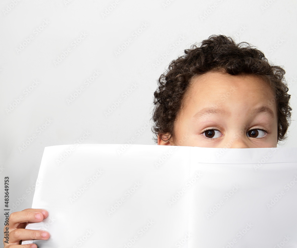 boy reading newspaper and looking at the paper been educated with white background stock photo boy reading newspaper and looking at the paper been educated with white background stock photo