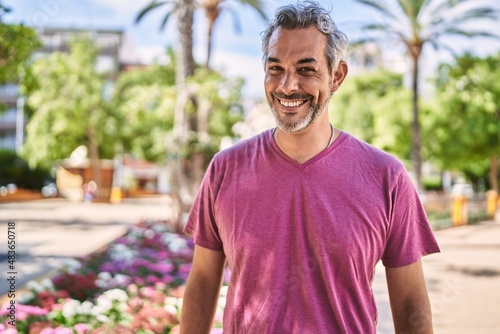 Middle age hispanic man smiling confident at park