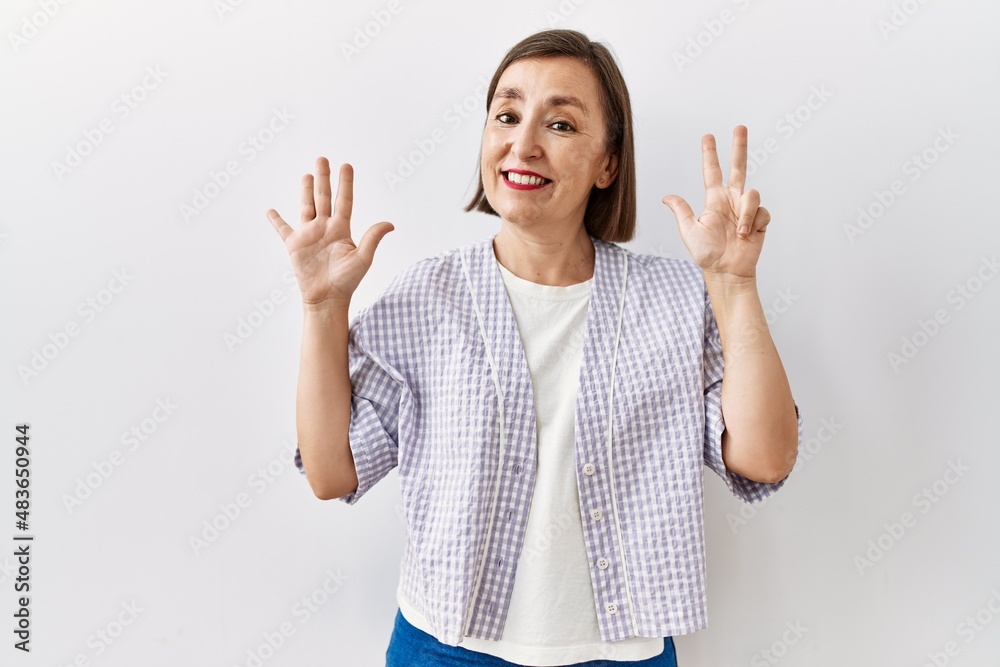 Beautiful middle age hispanic woman standing over isolated background pointing to the eye watching you gesture, suspicious expression Beautiful middle age hispanic woman standing over isolated background pointing to the eye watching you gesture, suspicious expression