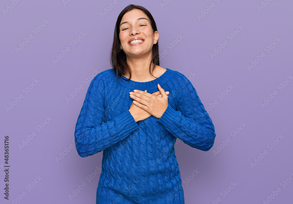 Young hispanic woman wearing casual clothes smiling with hands on chest with closed eyes and grateful gesture on face. health concept. Young hispanic woman wearing casual clothes smiling with hands on chest with closed eyes and grateful gesture on face. health concept.