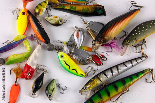 Lots of fishing lures for predatory fish on white photo