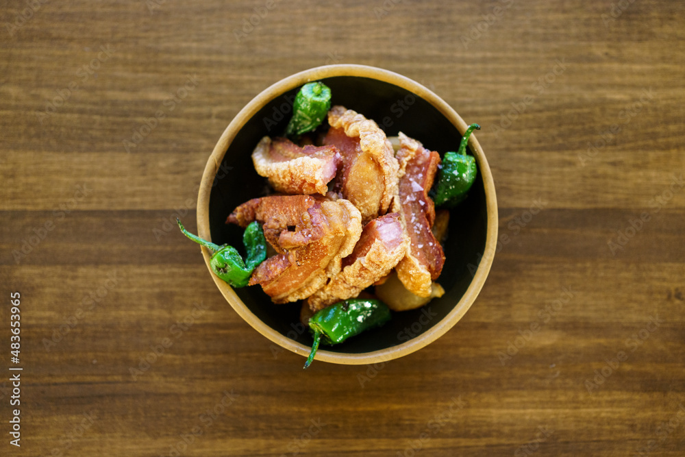 Fried meat served in bowl with peppers Fried meat served in bowl with peppers