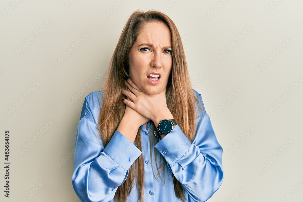Young blonde woman wearing casual blue shirt shouting and suffocate because painful strangle. health problem. asphyxiate and suicide concept. Young blonde woman wearing casual blue shirt shouting and suffocate because painful strangle. health problem. asphyxiate and suicide concept.