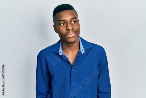 Young african american man wearing casual clothes looking to side, relax profile pose with natural face and confident smile.