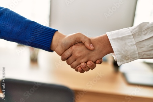 Women hands signing contract with handshake at the office.