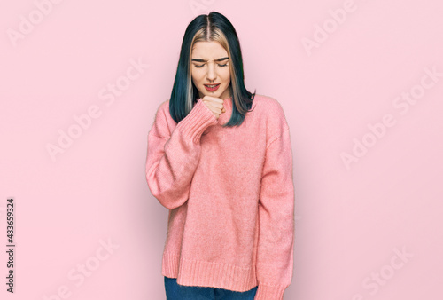 Young modern girl wearing pink wool winter sweater feeling unwell and coughing as symptom for cold or bronchitis. health care concept. © Krakenimages.com