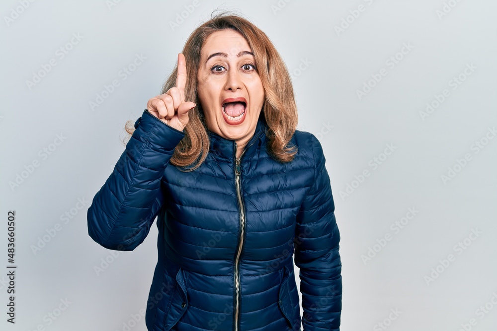 Middle age caucasian woman wearing casual clothes pointing finger up with successful idea. exited and happy. number one. Middle age caucasian woman wearing casual clothes pointing finger up with successful idea. exited and happy. number one.